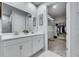 Bright bathroom featuring a double vanity, marble countertop, and walk-in closet at 3753 Maxwell Park Dr, Sun City Center, FL 33573