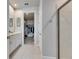 Open view of ensuite bathroom leading to walk-in closet and frameless shower at 3753 Maxwell Park Dr, Sun City Center, FL 33573