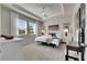 A spacious bedroom with a tray ceiling, carpet flooring and large windows at 3753 Maxwell Park Dr, Sun City Center, FL 33573