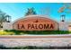 A welcoming La Paloma community sign features stone accents and lush landscaping at 3753 Maxwell Park Dr, Sun City Center, FL 33573