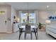 Modern dining area with stylish lighting, decor, and seating for four at 3753 Maxwell Park Dr, Sun City Center, FL 33573