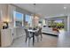 Well lit dining area with table, chairs, and view to the exterior living space at 3753 Maxwell Park Dr, Sun City Center, FL 33573