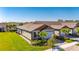 Charming home exterior with lush landscaping, a well-manicured lawn and a two car garage at 3753 Maxwell Park Dr, Sun City Center, FL 33573
