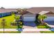 Charming single-story home with a well-manicured lawn, lush landscaping, and a two-car garage at 3753 Maxwell Park Dr, Sun City Center, FL 33573