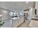 Large kitchen island with stainless steel appliances and modern white cabinets at 3753 Maxwell Park Dr, Sun City Center, FL 33573