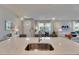Kitchen island with sink and view of the dining and living areas at 3753 Maxwell Park Dr, Sun City Center, FL 33573