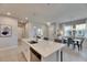 Kitchen island featuring a sink, dishwasher, and space for dining at 3753 Maxwell Park Dr, Sun City Center, FL 33573