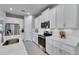 Bright kitchen with white cabinets, stainless steel appliances, and tile flooring at 3753 Maxwell Park Dr, Sun City Center, FL 33573