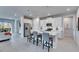 Open kitchen with island seating and stainless appliances, seamlessly connected to living spaces at 3753 Maxwell Park Dr, Sun City Center, FL 33573