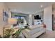 Bright living room with sliding doors to the outdoor patio and neutral decor, with plants adding a pop of color at 3753 Maxwell Park Dr, Sun City Center, FL 33573