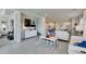Comfortable living room featuring a white sofa, tile flooring, and seamless flow to the kitchen and dining areas at 3753 Maxwell Park Dr, Sun City Center, FL 33573