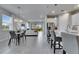 Bright, open-concept living space featuring modern decor, stainless steel appliances, and tile flooring at 3753 Maxwell Park Dr, Sun City Center, FL 33573