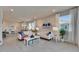 Comfortable living room featuring white sofas, tile flooring, and seamless flow to the kitchen and dining areas at 3753 Maxwell Park Dr, Sun City Center, FL 33573