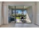 The screened patio features comfortable seating, a dining table, and a view of the lush backyard at 3753 Maxwell Park Dr, Sun City Center, FL 33573