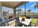 Covered patio with comfortable seating and dining area, perfect for enjoying the outdoors at 3753 Maxwell Park Dr, Sun City Center, FL 33573