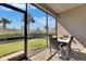 The screened patio features comfortable seating, a dining table, and a view of the lush backyard at 3753 Maxwell Park Dr, Sun City Center, FL 33573