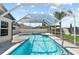 Beautiful in-ground pool with screened enclosure, offering ample room for activities at 381 Tavernier Cir, Oldsmar, FL 34677