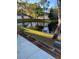 Scenic backyard featuring a serene pond with lush landscaping and mature trees at 3911 La Costa Ln, Largo, FL 33771