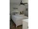 Cozy bedroom with a ceiling fan, neutral decor, and plush bedding at 3911 La Costa Ln, Largo, FL 33771