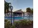 Community pool area surrounded by lush landscaping and mature trees at 3911 La Costa Ln, Largo, FL 33771