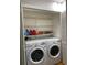 Organized laundry closet with front loading washer and dryer and ample shelving at 3911 La Costa Ln, Largo, FL 33771