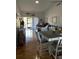 Bright living room with hardwood floors, vaulted ceiling, and views of a pond at 3911 La Costa Ln, Largo, FL 33771