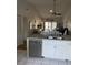 Open-concept living area with kitchen island, hardwood floors, and vaulted ceiling at 3911 La Costa Ln, Largo, FL 33771
