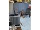 Patio area with AC unit, chairs and decorative windmill at 3911 La Costa Ln, Largo, FL 33771