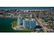 Aerial view of condo community with pool, shuffleboard court, and waterfront views at 420 64Th Ave # 907, St Pete Beach, FL 33706
