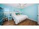 Light-filled bedroom showcasing wood floors, water view and king bed with charming coastal accents at 420 64Th Ave # 907, St Pete Beach, FL 33706