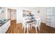 Charming dining area featuring a white table with seating for four adjacent to an updated kitchen with white cabinets at 420 64Th Ave # 907, St Pete Beach, FL 33706