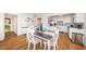 Bright dining area with modern table that seats four, and a stylish kitchen with updated appliances and eye-catching backsplash at 420 64Th Ave # 907, St Pete Beach, FL 33706