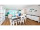 Inviting dining room with modern furnishings and abundant natural light from the sliding glass door at 420 64Th Ave # 907, St Pete Beach, FL 33706