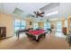 Fun game room includes pool table, foosball, and large windows with water views at 420 64Th Ave # 907, St Pete Beach, FL 33706