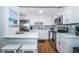 Well-lit kitchen with stainless steel appliances, white cabinets, and bar seating at 420 64Th Ave # 907, St Pete Beach, FL 33706