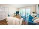 Inviting living room with a comfortable blue sofa, striped armchairs, and a sliding glass door leading to a balcony with ocean views at 420 64Th Ave # 907, St Pete Beach, FL 33706