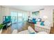 Comfortable living room with stylish furniture, a TV, and access to a balcony offering beautiful views at 420 64Th Ave # 907, St Pete Beach, FL 33706