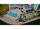 Aerial view highlighting the community pool, lounge area, shuffleboard and marina with waterfront access at 420 64Th Ave # 907, St Pete Beach, FL 33706