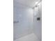 Shower with herringbone tiled floor, subway tiles, and rainfall shower head at 420 64Th Ave # 907, St Pete Beach, FL 33706