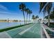 Enjoy a waterfront shuffleboard court surrounded by lush greenery and tall palm trees at 420 64Th Ave # 907, St Pete Beach, FL 33706