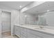 Bathroom with double sinks, white cabinets and mirror at 4212 Cloud Hopper Way, Lutz, FL 33559
