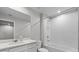 Bright bathroom features a shower-tub, large mirror and white cabinets at 4212 Cloud Hopper Way, Lutz, FL 33559