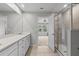 Bathroom with double sinks, walk-in shower and neutral paint at 4212 Cloud Hopper Way, Lutz, FL 33559