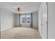 Bright bedroom with natural light, neutral carpet, and a minimalist design at 4212 Cloud Hopper Way, Lutz, FL 33559