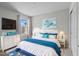 Comfortable bedroom with nautical-themed decor, a cozy bed, and ample natural light at 4212 Cloud Hopper Way, Lutz, FL 33559