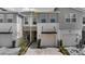 New construction townhome with paver driveway and front-entry garage, surrounded by neighborhood homes at 4212 Cloud Hopper Way, Lutz, FL 33559