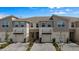 Beautiful new construction townhomes boasting neutral colors, manicured landscaping, and paver driveway at 4212 Cloud Hopper Way, Lutz, FL 33559