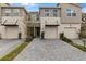 Modern townhome featuring attached garages and paved driveway at 4212 Cloud Hopper Way, Lutz, FL 33559