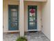 Inviting double front doors with glass panes and a heart wreath on one at 4212 Cloud Hopper Way, Lutz, FL 33559