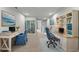 Well-lit home office with dual workstations, bookshelves, and calming blue accents for a productive atmosphere at 4212 Cloud Hopper Way, Lutz, FL 33559